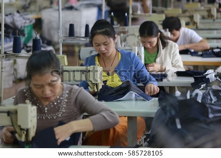 JIANGXI CHINA-SEP 26,2013:Female labors work in a cloth factory which export to European Union in Jiujiang, Jiangxi province, East China.