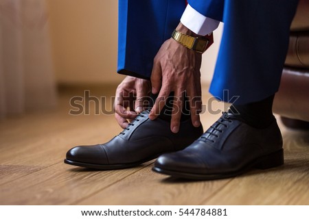 businessman clothes shoes, Politician, man's style, Businessman buttoning his shirt,male hands closeup, American, European businessman, People, business, fashion and clothing concept