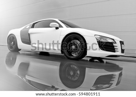 Vinnitsa, Ukraine - November 11, 2012. Audi R8 concept car. showroom.Presentation. Presentation of the new model Audi car - R8.Front of the car,front-side, logo .Black and white autophoto