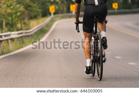Asian men are cycling road bike morning uphill on the road with soft tone