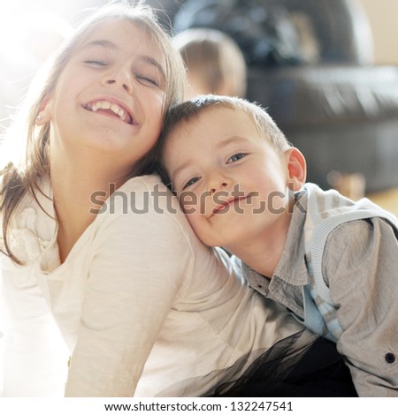 Portrait of adorable brother and sister smile and laugh together