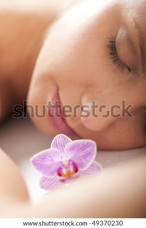 Close-up of a relaxed woman receiving spa treatment, selective focus