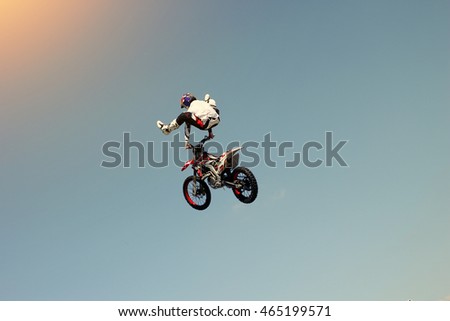 Biker stuntman doing a stunt in the air