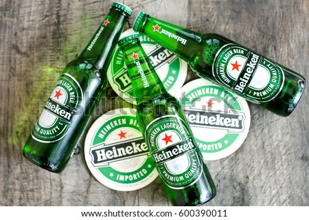 DORKOVO, BULGARIA - MARCH 13, 2017: 3 bottle of Heineken light beer on wooden background.Heineken Lager Beer is the flagship product of Heineken International breweries