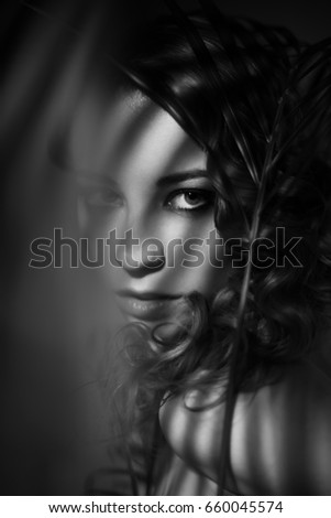 Dramatic black and white portrait of girl with shadows on her face Dramatic black and white portrait of girl with shadows on her face