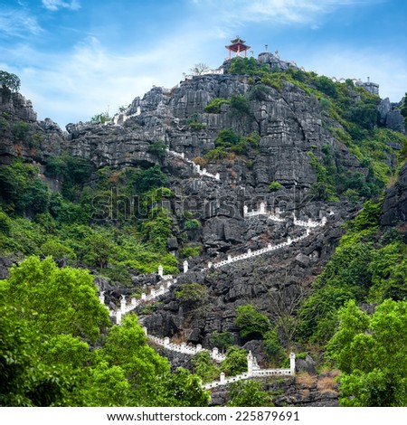 Stairway at limestone mountain to Hang Mua view point. Popular tourist attraction at Tam Coc, Ninh Binh. Vietnam travel landscapes and destinations