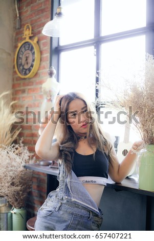The Olw,Pak Khat,Bueng Kan,Thailand-2017-06-05 : A Sexy woman wearing black Calvin Klein sport bra in coffee shop.
