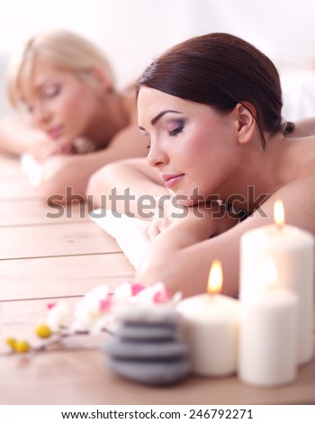 Two young beautiful women relaxing and enjoying at the spa