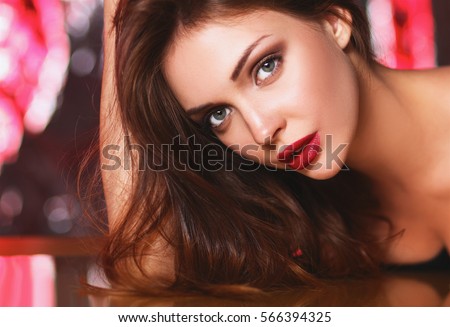 Portrait of beautiful girl with trendy makeup lying