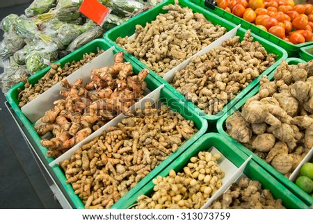 A portrait of turmeric root and other herbs for alternative medicine ,spa products and food ingredient, in a market stall