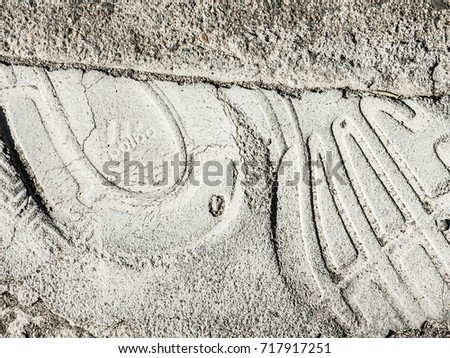 SYDNEY, AUSTRALIA. – On September 18, 2017 – Foot prints from the shoe which is stamped ADIDAS shoe brand logo on the surface of a footpath in Sydney.