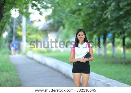 https://thumb7.shutterstock.com/display_pic_with_logo/4502014/582110545/stock-photo-girl-female-teenager-with-black-hair-in-a-bob-white-east-asian-woman-green-park-with-a-backpack-582110545.jpg