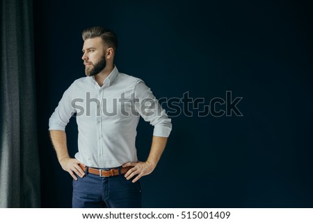 Man wearing white dress shirt standing sideways. Man wearing white dress shirt standing sideways.