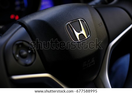 Kuala Lumpur, Malaysia - July 15, 2017 : Honda Black Steering Wheel And Silver Logo. Honda Motor Co., Ltd. is a Japanese public multinational conglomerate corporation.