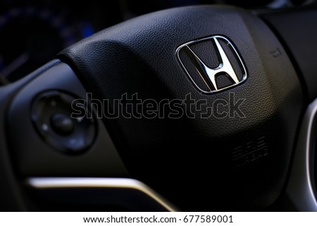 Kuala Lumpur, Malaysia - July 15, 2017 : Honda Black Steering Wheel And Silver Logo. Honda Motor Co., Ltd. is a Japanese public multinational conglomerate corporation.