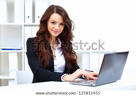 Young pretty business woman with notebook in the office