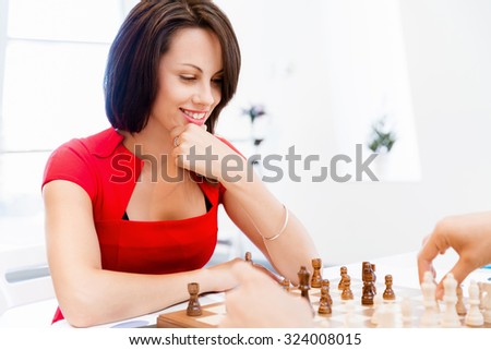 Business woman sitting in front of chess and planning