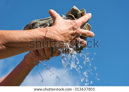 Hands Squeeze Wet Fabric Against Blue Stock Pto 14 ...