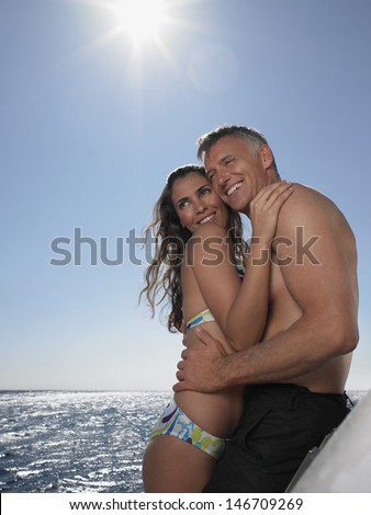 https://thumb7.shutterstock.com/display_pic_with_logo/487144/146709269/stock-photo-side-view-of-happy-romantic-couple-looking-away-while-standing-on-yacht-146709269.jpg