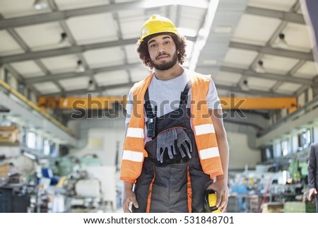 Portrait of young man wearing protective clothing in metal industry