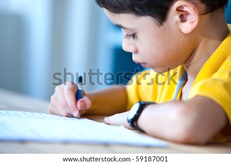 Young boy doing his homework in a home environment
