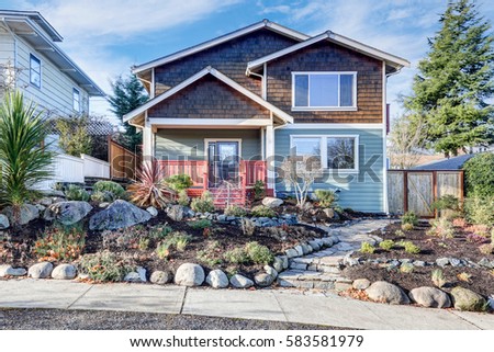 nice craftsman home exterior on blue sky background well kept frontyard with natural stone landscape - Craftsman Home Exterior nice craftsman home exterior on blue sky background well kept frontyard with natural stone landscape - Craftsman Home Exterior