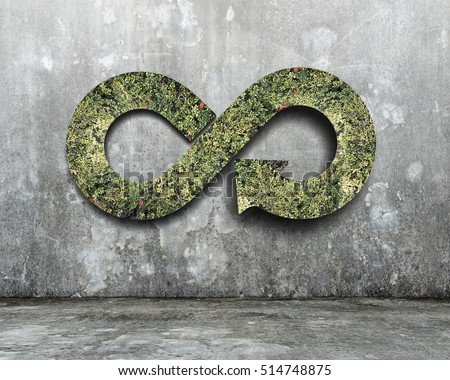 Green circular economy concept. Arrow infinity symbol with grass on concrete wall.