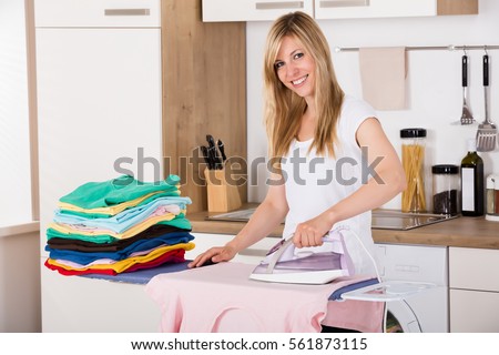 stock-photo-young-smiling-woman-ironing-