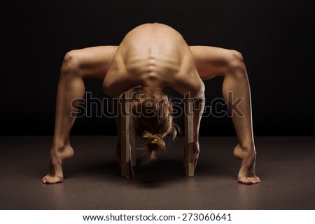 Beautiful back of young woman over dark background