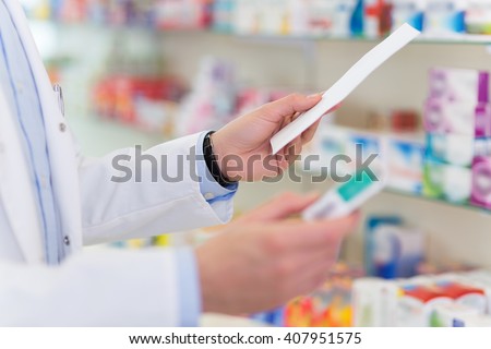 Pharmacist filling prescription in pharmacy