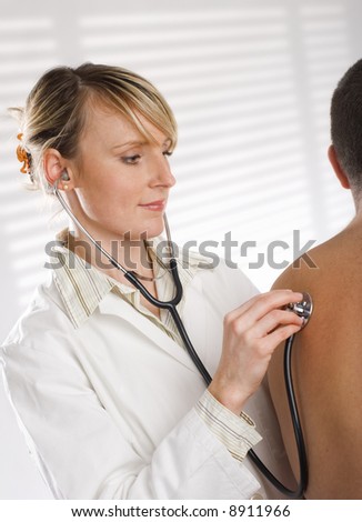 Male Doctor Examining Female Patient In Emergency Room 