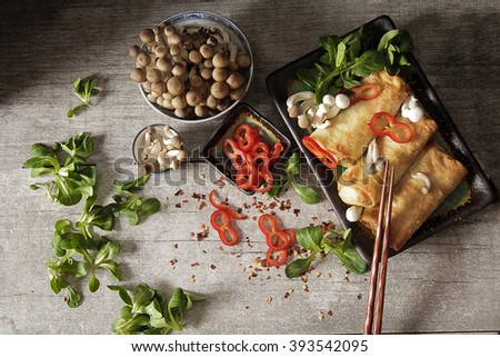 Japanese food style. Fried spring rolls with vegetables and shimeji mushrooms, on a gray background. Flat Lay. Top view. Chinese style