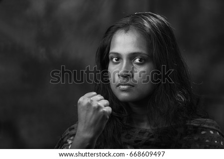 Black and white portrait of indian woman shows her fist Black and white portrait of indian woman shows her fist