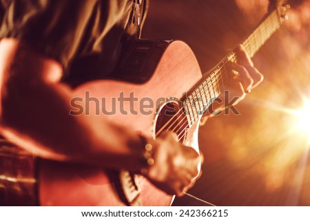 Acoustic Guitar Playing. Men Playing Acoustic Guitar Closeup Photography.