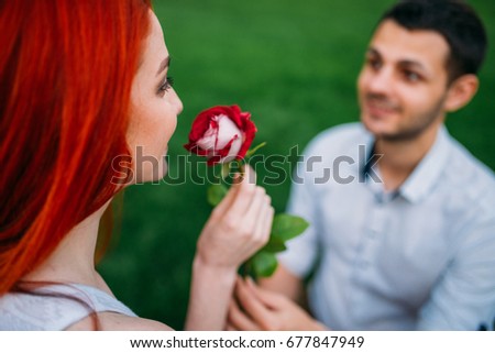 https://thumb7.shutterstock.com/display_pic_with_logo/539572/677847949/stock-photo-young-man-gives-flower-to-woman-romantic-meeting-677847949.jpg