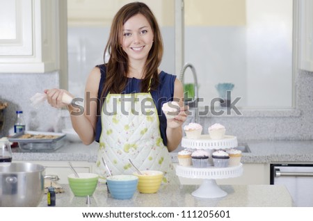 Woman Decorating Cupcakes cupcake decorating stock photos, royalty-free images & vectors Woman Decorating Cupcakes cupcake decorating stock photos, royalty-free images & vectors