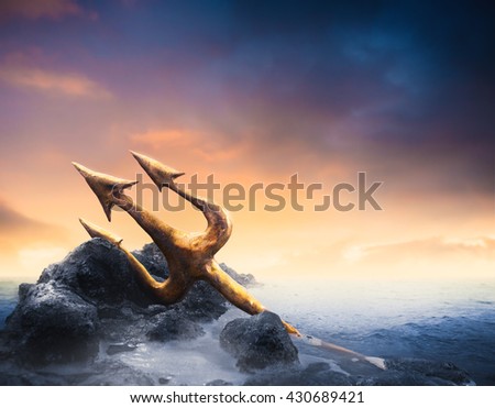 High contrast image of Poseidon's trident resting on some rocks by the sea