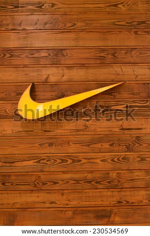 HONG KONG - APRIL 02: Nike, Inc. logo on wooden wall on April 02, 2014 in Hong Kong. The company was founded on January 25, 1964, as Blue Ribbon Sports, by Bill Bowerman and Phil Knight