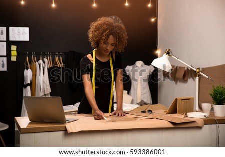 A young fashion designer working on her atelier