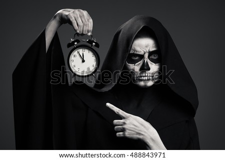 [Image: stock-photo-scary-death-hold-a-watch-in-...843971.jpg]