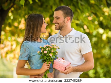 https://thumb7.shutterstock.com/display_pic_with_logo/559060/333745289/stock-photo-loving-young-couple-on-a-date-with-flowers-and-with-a-gift-in-the-park-333745289.jpg