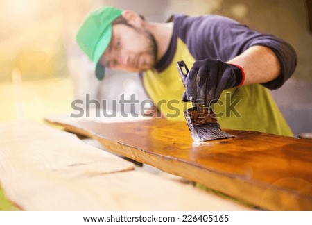 stock photo handyman varnishing pine wooden planks in patio outside the new house 226405165