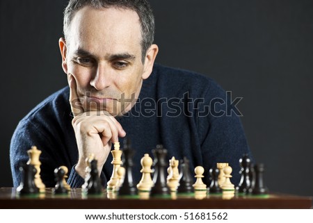 Chessboard with man thinking about chess strategy