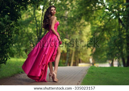 stock photo young beautiful woman in long pink evening dress walking path in park fashion style portrait of 335023157