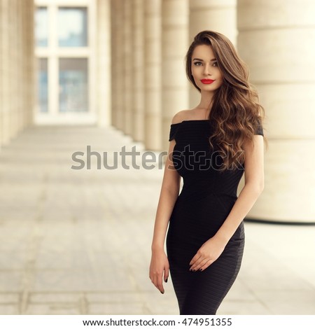 https://thumb7.shutterstock.com/display_pic_with_logo/571009/474951355/stock-photo-young-elegant-girl-posing-at-city-street-pretty-beautiful-business-woman-in-elegant-black-dress-474951355.jpg