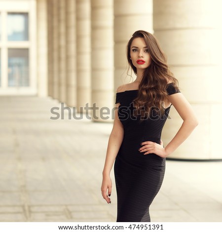 https://thumb7.shutterstock.com/display_pic_with_logo/571009/474951391/stock-photo-young-elegant-girl-posing-at-city-street-pretty-beautiful-business-woman-in-elegant-black-dress-474951391.jpg