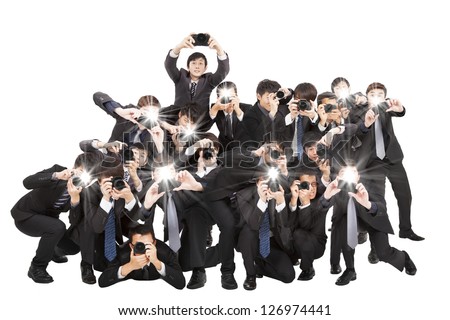 many photographers holding camera pointing to you and isolated on white