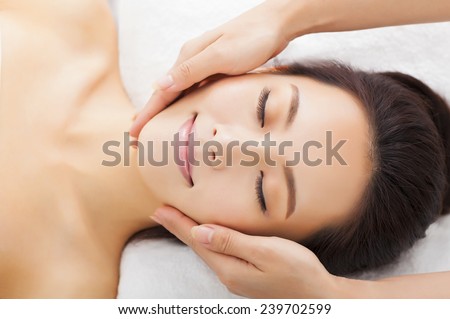 massage of face for woman in spa salon