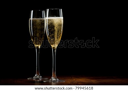 two glass with champagne on a wooden table
