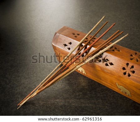 Incense sticks against a timber box